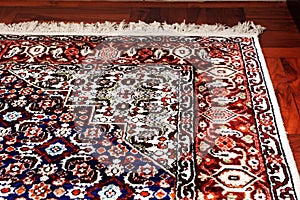 Persian Oriental Rug on wooden floor photo