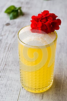 Persian Saffron Milkshake with red flowers.