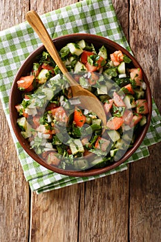 Persian Shirazi vegetable salad closeup on a plate. Vertical top view