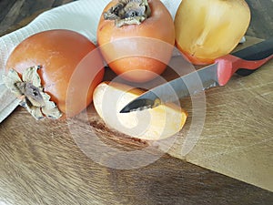 Persimmon freshness on a wooden knife table