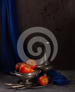 Fresh persimmon still life with vintage objects