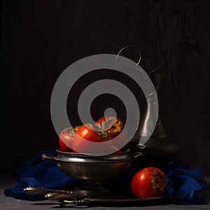 Fresh persimmon still life with vintage objects