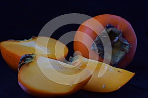 Persimmons on a black background