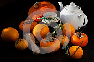 Persimmons, tangerines, oranges and pumpkin