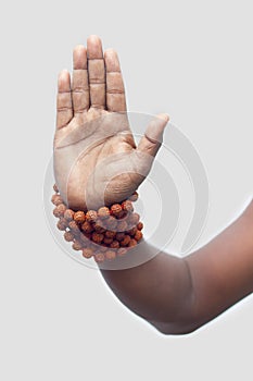 A persist showing his hand with rudraksha beads,for blessing.