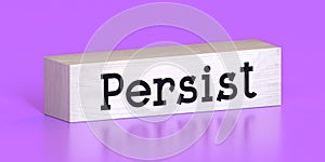 Persist - word on wooden block