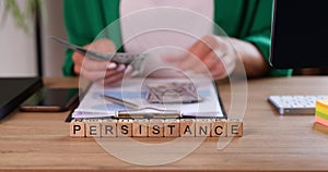 Persistence is written on wooden cubes, a close-up