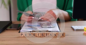 Persistence is written on wooden cubes, a close-up