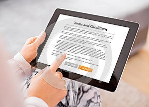 Person accepting terms and conditions on tablet photo