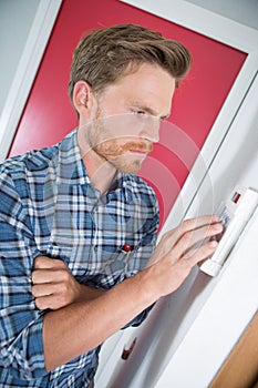 Person adjusting thermostat control on central heating