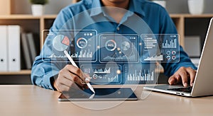 Person analyzing digital financial charts on tablet and laptop business data