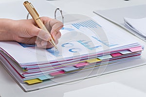 Person Analyzing Graphs At Desk