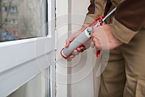 Person Applying Silicone Sealant