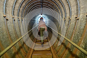 Person ascending an underground tunnel