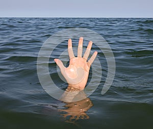 person asking for help while in danger of drowning in the deep sea water