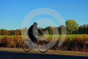 person on bike in shadowin autumn