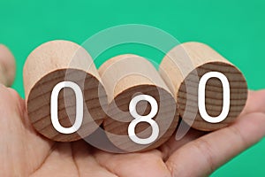 A person with a block written as 080