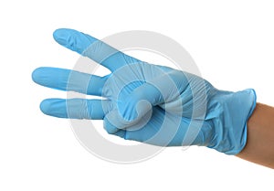 Person in blue latex gloves showing number three against white background, closeup on hand