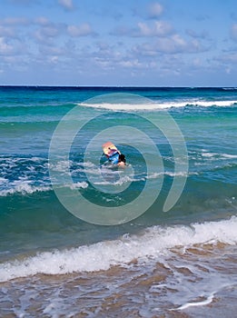 Person with body board in sea