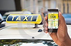 Person Booking Taxi On Mobile Phone