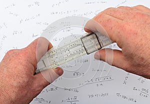 Person calculating on a slide rule