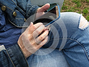 Person In Casual Jeans Texting In Cellphone