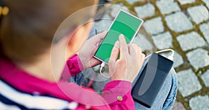 Person Charging Smartphone with Portable Battery