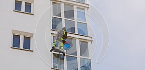 Person cleaning building window