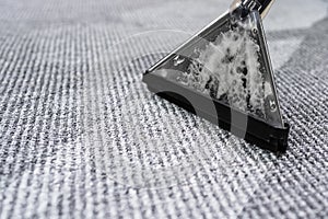 Person Cleaning Carpet With Vacuum Cleaner