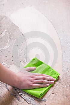 Person cleaning dirty wood floor