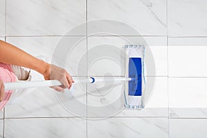 Person Cleaning Floor With Mop