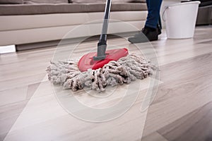 Person Cleaning Floor With Mop