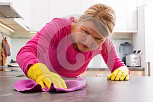 Person cleaning the hard stains from counter