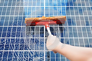 Person Cleaning Solar Panel