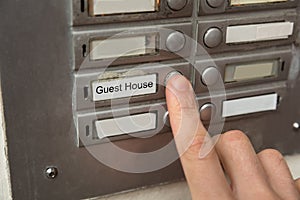 Person Clicking On Door Bell Button photo