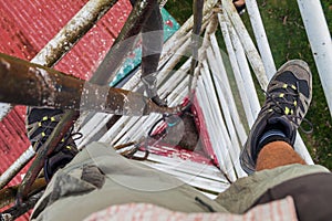 Person climbing a triangular guyed lattice mast near Santa Elena village, Costa Ri