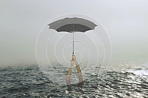 Person clinging to an umbrella in the middle of the ocean tries to save his life, concept of success and failure