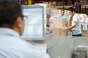 Person At Computer Terminal In Distribution Warehouse