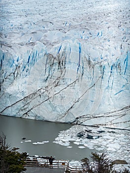 Person contemplating the vast beauty of a glacier landscape