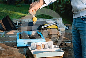 Person cooking eggs on camping stove