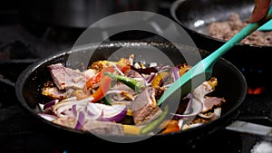 Person cooking and preparing traditional Thai cuisine in pans.