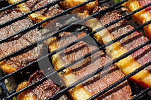 Person cooking steaks on a barbecue grill