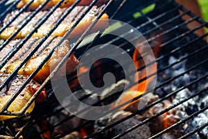 Person cooking steaks on a barbecue grill