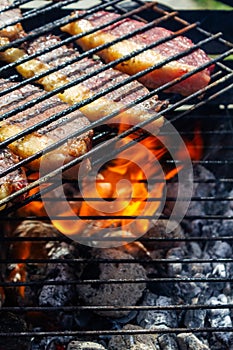 Person cooking steaks on a barbecue grill