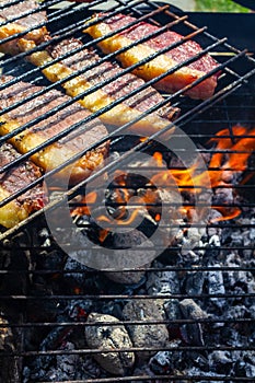 Person cooking steaks on a barbecue grill