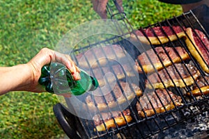 Person cooking steaks on a barbecue grill