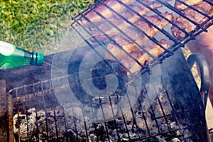 Person cooking steaks on a barbecue grill