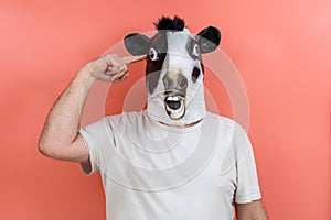 Person with cow mask making a sign of madness