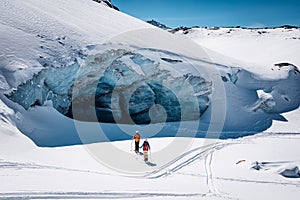 a person is cross country skiing in the mountains in front of a small cave