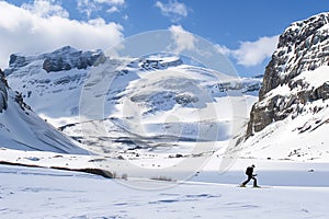 person crosscountry skiing across alpine landscape photo